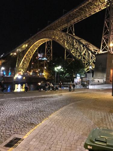 a bridge at night with people walking on the street at Residencial clérigos ROOM 3 in Porto