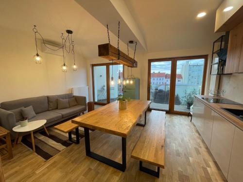 a living room with a couch and a table at Apartmány Marienhof in Znojmo