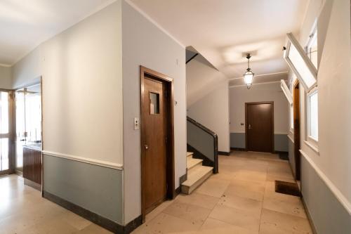 an empty hallway with stairs and a door at Fleming Suites by Hili in Rome