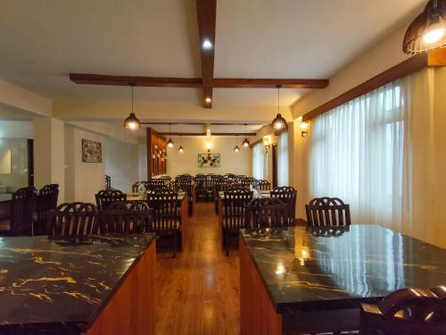 a large room with chairs and a large dining room at Sila Norphel Pelling in Pelling