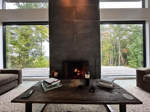 a living room with a fireplace and a table at Lost Ridge in Lenoir