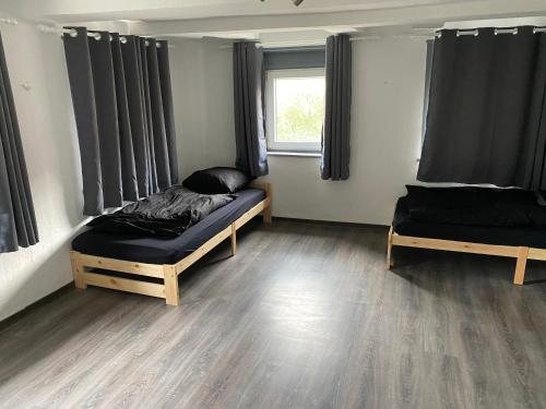 a room with two beds and a window at Zimmervermietung M.Simon in Ronnenberg