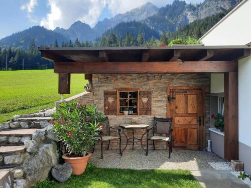 a patio with a table and chairs next to a building at Haus Adrian in Wald am Arlberg
