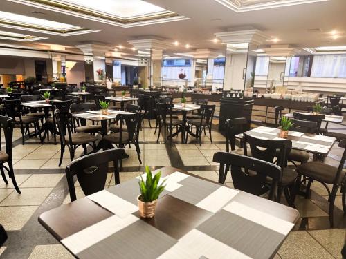 a restaurant with tables and chairs in a room at San Rafael Comfort Class Hotel in Foz do Iguaçu