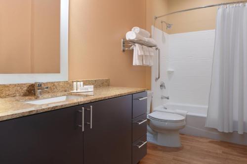 a bathroom with a sink and a toilet and a tub at TownePlace Suites by Marriott Lake Jackson Clute in Clute