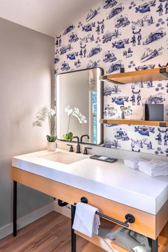 a bathroom with a sink and blue and white wallpaper at The Incline Lodge in Incline Village