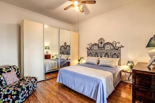 a bedroom with a large bed and a chair at The Retreat Rustic Charm, Views & Pool by Feeling Italy in Massa Lubrense