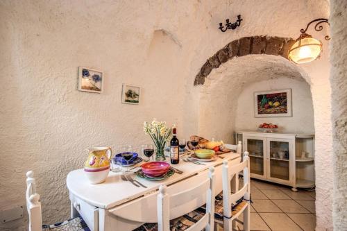 a kitchen with a white table with food on it at The Retreat Rustic Charm, Views & Pool by Feeling Italy in Massa Lubrense