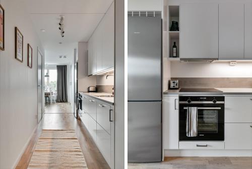 a kitchen with white appliances and a hallway at Cosy Urban Home in Stockholm in Stockholm