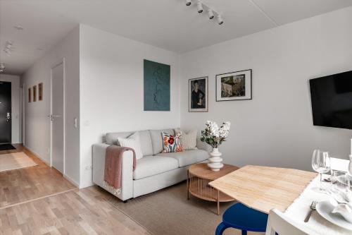a living room with a couch and a table at Cosy Urban Home in Stockholm in Stockholm
