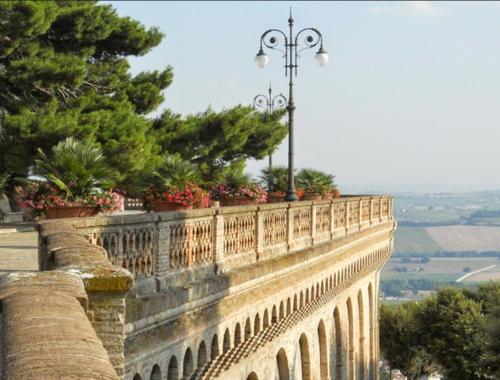 a stone wall with a street light on top of it at Affittacamere Osimo Rose in Osimo