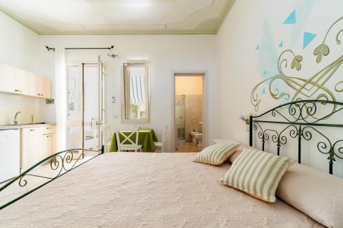 1 dormitorio con 1 cama grande y cocina en Appartamento Verde 1, en Castrignano del Capo