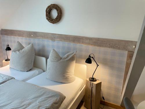 a bedroom with a bed and a lamp and a mirror at Weberhof - Münster 3 in Münster