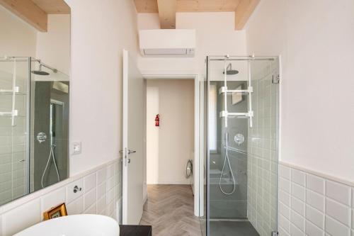 a bathroom with a shower and a glass shower stall at Piazza Savonarola 13 in Imola