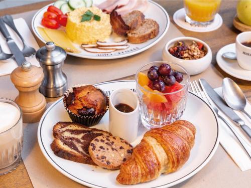 a table with two plates of breakfast food on it at MOB House in Saint-Ouen