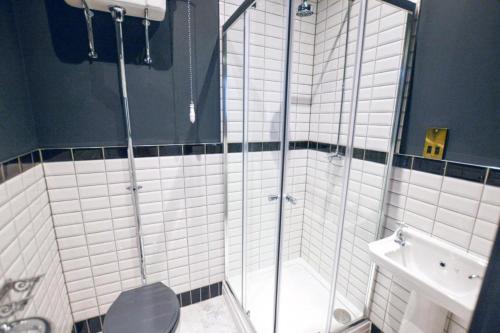a bathroom with a shower and a toilet and a sink at Stylish En-suite in the heart of Manchester in Manchester
