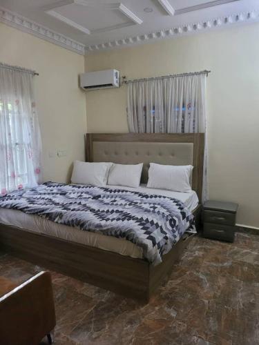 a bedroom with a large bed in a room at Dazzle hotels and apartments in Abuja