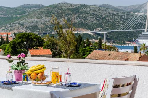 a table with a bowl of fruit and a bowl of bananas at Apartment Marina View in Dubrovnik