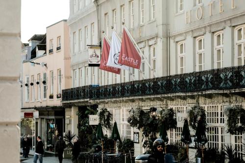 a building with flags on the side of it at Castle Hotel Windsor in Windsor