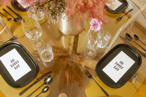 a table with two cell phones on a table with glasses at Supernova Royal Residence in Novi Sad
