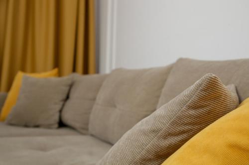a couch with pillows on it in a living room at Supernova Royal Residence in Novi Sad