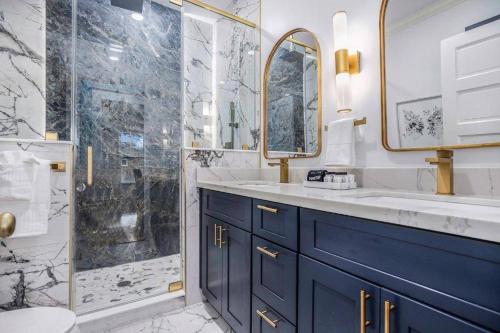 a bathroom with a blue sink and a shower at Luxury Designer Villa by the Beach Bright Beautiful Brand New in Galveston