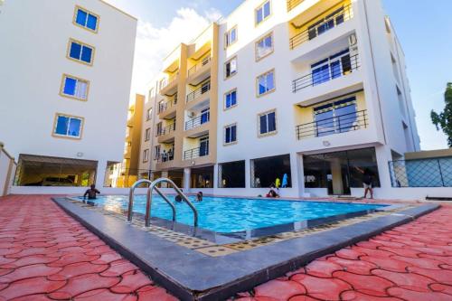 a swimming pool in front of a building at LES INTERNATIONAL in Mombasa