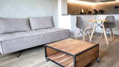 a living room with a couch and a table and chairs at Komody in Delfoi