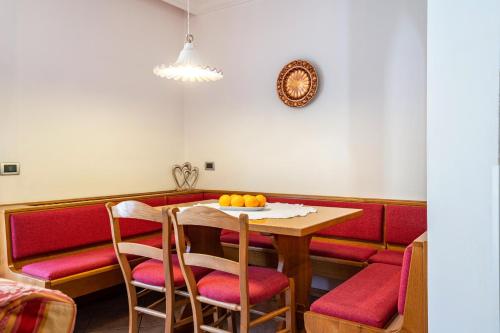 a dining room with a table and chairs with oranges on it at Villa Lory 1 in Canazei