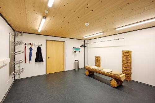 a room with a bench in the middle of a room at Arlberg Öko Ferienwohnungen in Innerbraz