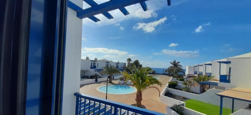 a view of the pool from the balcony of a villa at Las Moreras Playa Blanca in Playa Blanca