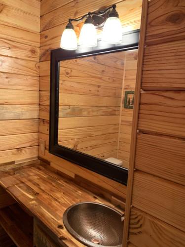 a bathroom with a sink and a mirror at Gatlinburg Mountain Condo in Gatlinburg
