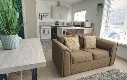 a living room with a couch and a table at #1 Limes by DerBnB, Modern 1 Bedroom Apartment, Free Parking, WI-FI & Netflix Near Royal Derby Hospital in Derby