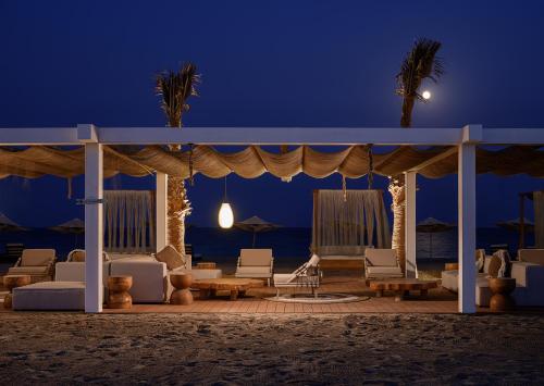 a gazebo on the beach at night at Ramlah Resort Sealine Beach in Mesaieed