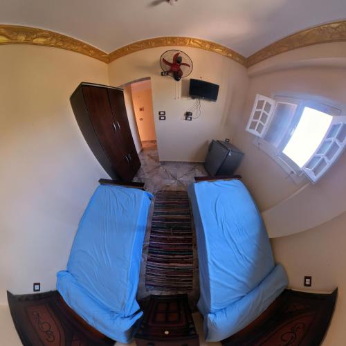 an overhead view of a room with a staircase with blue chairs at Siwa star in Siwa