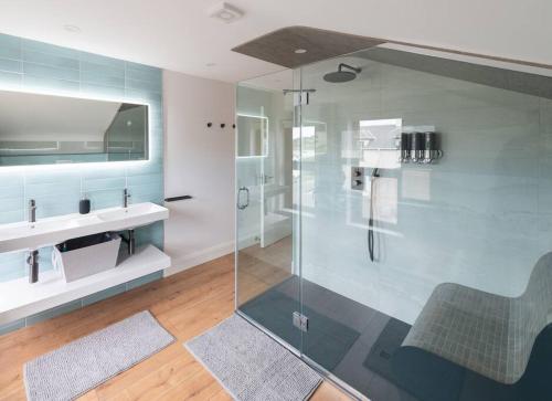 a bathroom with a glass shower and a sink at Rosapenna Golf Cottage, Donegal, Ireland in Downings