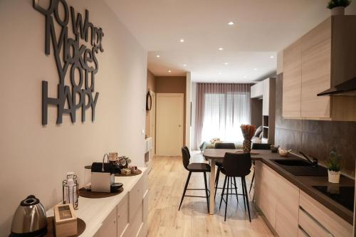 a kitchen and living room with a counter and chairs at Borgo House in Sasso Marconi