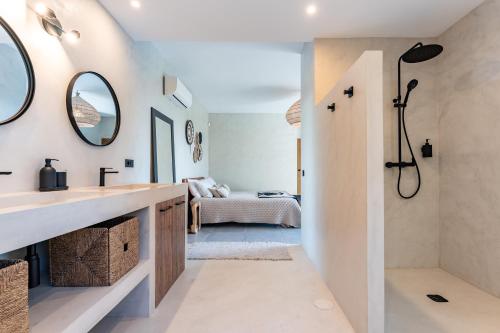a bathroom with a sink and a shower and a bed at Casa Rocas in Mijas
