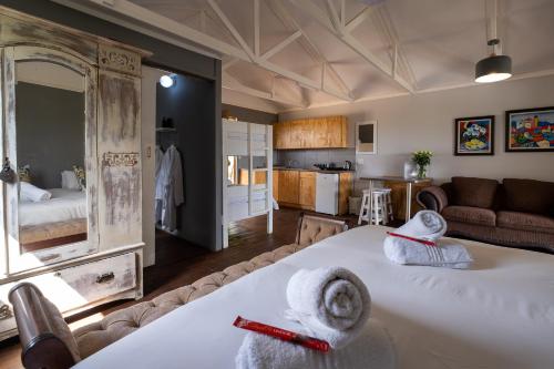 a living room with two beds and a kitchen at Goshen Guest Farm in Edenburg