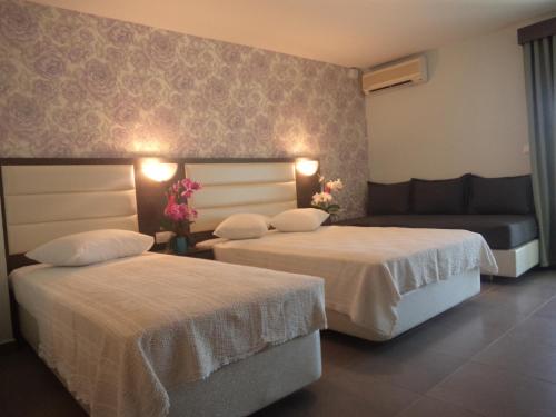 Ένα ή περισσότερα κρεβάτια σε δωμάτιο στο Hotel Dioni