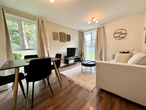 a living room with a couch and a dining room table at Stylish modern flat, Chapel Allerton sleeps 4 in Moortown