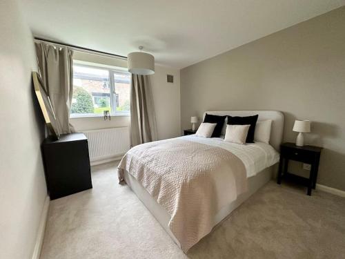 a bedroom with a white bed and a window at Stylish modern flat, Chapel Allerton sleeps 4 in Moortown