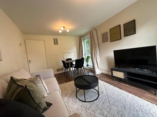 a living room with a couch and a table at Stylish modern flat, Chapel Allerton sleeps 4 in Moortown