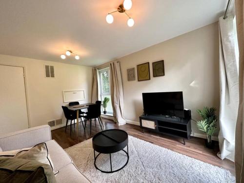 a living room with a couch and a table at Stylish modern flat, Chapel Allerton sleeps 4 in Moortown