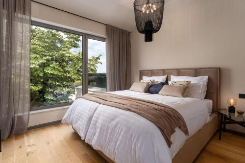 a bedroom with a large bed and a large window at Luxury Villa Lipa Tree with pool in Novigrad in Novigrad Istria