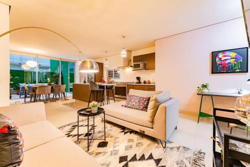 a living room with a couch and a table at Trendy La Roma Condo with Parking & Patio in Mexico City