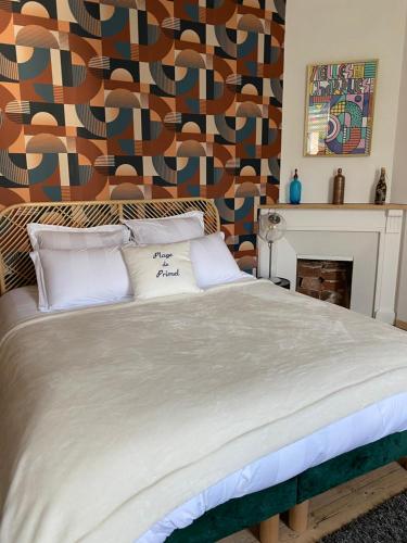 a large bed with two pillows in a bedroom at Les chambres de sainte barbe in Plougasnou