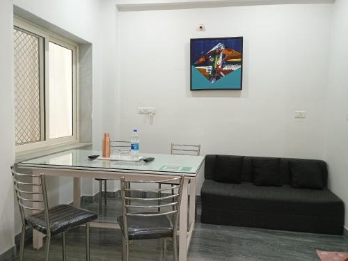 a living room with a table and a couch at CHOUDHARY WHITE HOUSE Udaipur in Udaipur