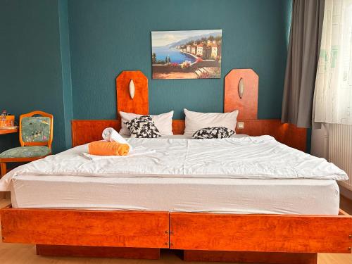 Schlafzimmer mit einem großen Bett mit einem Kopfteil aus Holz in der Unterkunft Bone To in Salzgitter