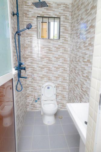 a bathroom with a toilet and a sink at Mangi Mangi Accomodation in Nungwi